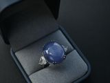 blue star sapphire ring in a black box on a black surface