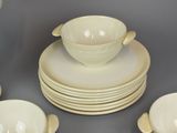 a lot of white dishes and cups on the table