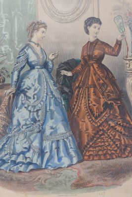 two women in dresses that are standing next to each other
