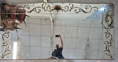 a man that is taking a picture of himself in the mirror