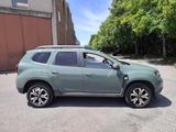 a picture of a green car parked in a parking lot