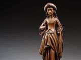 une image représentant une statue en bois d'une femme tenant un oiseau