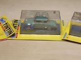 three boxed toy cars sitting on top of each other on a table