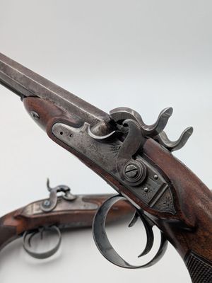 a close up of a gun on a white surface with a white background