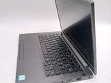 a laptop that is open on a white surface