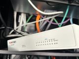 many cables and wires in the back of a rack