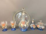 five pieces of glass and a decanter on a table
