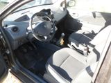 a car that is sitting in the dirt with its door open