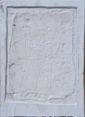 une image représentant un mur blanc sur lequel figure un petit relief représentant un homme et une femme