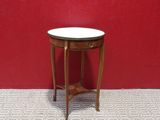 a small table with a white top in front of a red wall