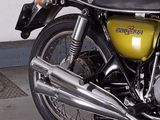 a yellow and black motorcycle parked in a garage