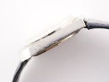 a close up of a watch on a white surface