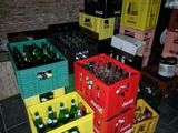 many crates of beer sitting on the floor in a room