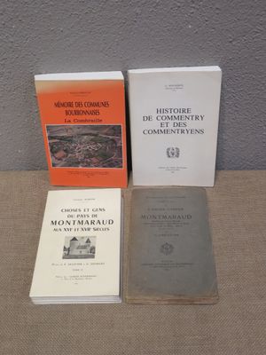 three books sitting on a table next to each other on top of a table