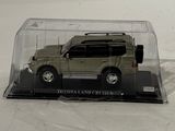 a toy car in a clear case on a white surface