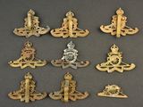 several different types of military badges are displayed on a gray surface