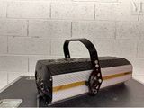 a black and white suitcase sitting on top of a table