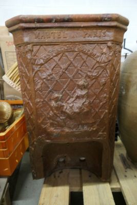 un grand pot marron posé sur une palette dans un entrepôt