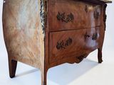 a small wooden chest of drawers on a white background