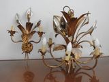 two wall sconces that are on a table