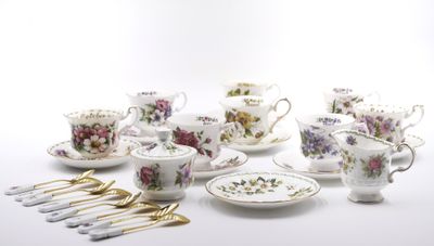 many different types of tea cups and saucers on the table