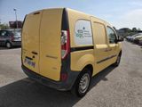 the back of a yellow van is parked in a parking lot