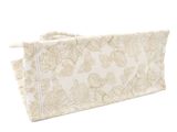 a close up of a white and gold bag on a white background