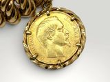 a close up of a gold coin with a chain around it