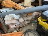 a pile of construction materials and tools on the ground