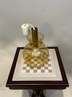 a small table with a glass vase on top of it