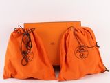 two orange bags are sitting next to each other on a white surface