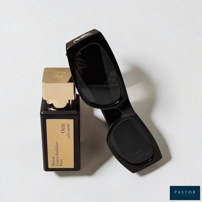 an image of a pair of sunglasses next to a bottle of perfume