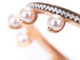 an image of a close up of a ring with pearls and diamonds
