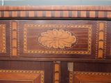 a wooden cabinet with a decorative design on it