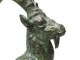 a statue of a goat that is standing on a pedestal