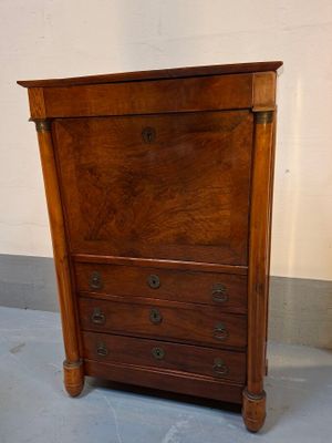 a small wooden cabinet with drawers on the floor
