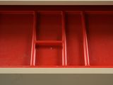 an image of a close up of a red drawer with compartments