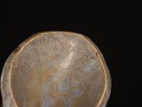 a close up of a bowl on a black surface