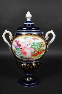 an image of a blue and white vase with flowers on it