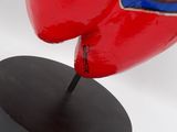 sculpture of a broken heart on a black base on a white background
