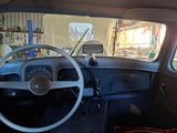 a steering wheel and dashboard of a car in a garage
