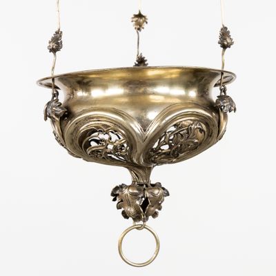 a large metal hanging bowl with a ring on it