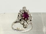 a silver ring with a red stone in it