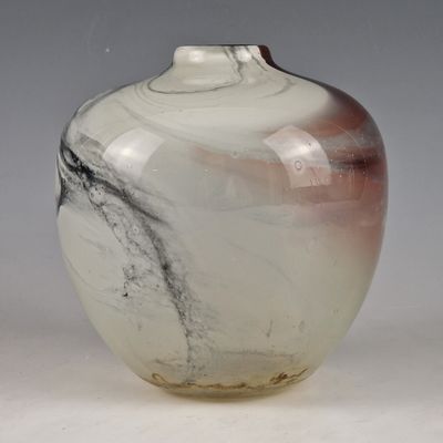 a glass vase with a black and white design on it