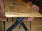 a wooden table with chairs around it in a room