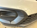 a close up of the front bumper of a white car
