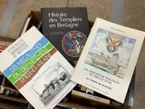 many books in a box on the floor