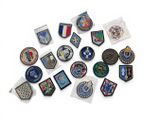a lot of badges that are on a white surface