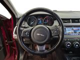 the interior of a car with a steering wheel and dashboard controls