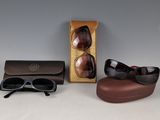 pair of sunglasses and sunglasses case sitting on a table next to a pair of sunglasses